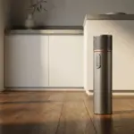 The Dyson PencilWash wet floor cleaner standing on a wooden floor.